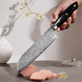 A Versatile Hand-Washable G18 Damascus Santoku Knife with a Black Steel Handle on The 67Th Floor, Suitable for Professional And Amateur Kitchen Use.
