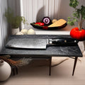 A black three-layer Damascus knife with VG10 high carbon steel, a Japanese precision knife for kitchen and restaurant use.